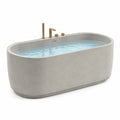 Baignoire îlot en résine de pierre beige avec robinetterie en laiton